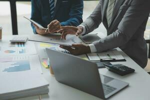 analyst or financial advisor provides advice on securities analysis and stock market management. Businessman showing documents through graphs and charts. Brainstorm and work together photo