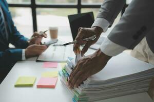 analyst or financial advisor provides advice on securities analysis and stock market management. Businessman showing documents through graphs and charts. Brainstorm and work together photo