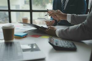 analyst or financial advisor provides advice on securities analysis and stock market management. Businessman showing documents through graphs and charts. Brainstorm and work together photo