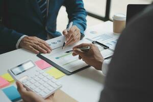 analyst or financial advisor provides advice on securities analysis and stock market management. Businessman showing documents through graphs and charts. Brainstorm and work together photo
