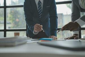 analyst or financial advisor provides advice on securities analysis and stock market management. Businessman showing documents through graphs and charts. Brainstorm and work together photo