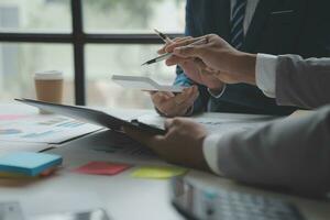 analyst or financial advisor provides advice on securities analysis and stock market management. Businessman showing documents through graphs and charts. Brainstorm and work together photo