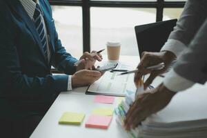 analyst or financial advisor provides advice on securities analysis and stock market management. Businessman showing documents through graphs and charts. Brainstorm and work together photo
