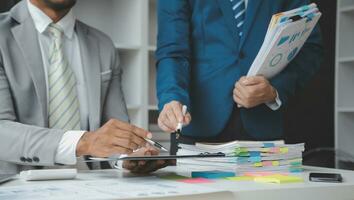 analyst or financial advisor provides advice on securities analysis and stock market management. Businessman showing documents through graphs and charts. Brainstorm and work together photo