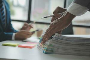 analyst or financial advisor provides advice on securities analysis and stock market management. Businessman showing documents through graphs and charts. Brainstorm and work together photo