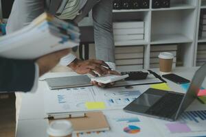 analyst or financial advisor provides advice on securities analysis and stock market management. Businessman showing documents through graphs and charts. Brainstorm and work together photo