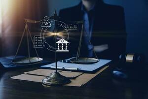 Justice and law concept.Male judge in a courtroom with the gavel, working with, computer and docking keyboard, eyeglasses, on table in morning light photo