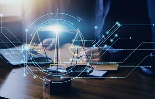 Justice and law concept.Male judge in a courtroom with the gavel, working with, computer and docking keyboard, eyeglasses, on table in morning light photo