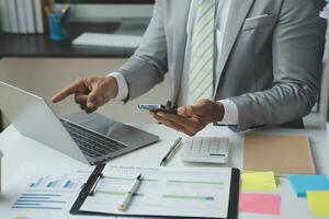 analyst or financial advisor provides advice on securities analysis and stock market management. Businessman showing documents through graphs and charts. Brainstorm and work together photo