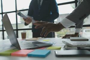 analyst or financial advisor provides advice on securities analysis and stock market management. Businessman showing documents through graphs and charts. Brainstorm and work together photo