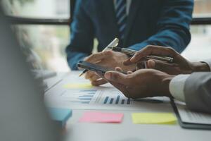 analyst or financial advisor provides advice on securities analysis and stock market management. Businessman showing documents through graphs and charts. Brainstorm and work together photo