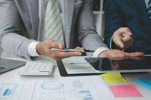 analyst or financial advisor provides advice on securities analysis and stock market management. Businessman showing documents through graphs and charts. Brainstorm and work together photo