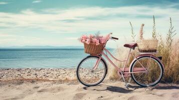 Bicycle with a basket sits on top of sand near the ocean photo