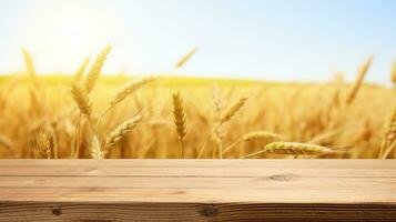 Wooden table with wheat field background photo