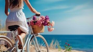 Bicycle with a basket sits on top of sand near the ocean photo