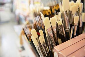 Paint brushes with synthetic and natural bristles of different softness displayed for sale in the creative art shop photo