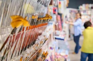 Selective focus on group of paintbrushes displayed for sale in creative art shop. Fine art. Painting. Creativity. Hobby photo