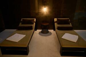 Modern spa center interior. Close-up of loungers in spa room at wellness spa complex. photo