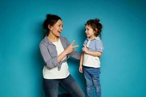 Mother and daughter playing a rock-paper-scissors game. Motherhood and childhood concept. photo