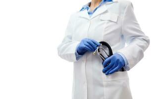 Hands in gloves holding a stethoscope in the pocket of a white medical care gown. Isolated on white background with copy space. photo