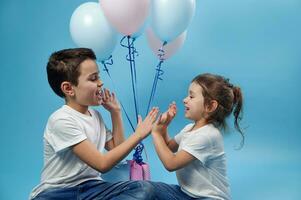 Boy and girl clapping hands, enjoying time together. Happy family relationships. photo