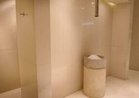 Ice tank in the luxurious hall of the bath and sauna with beige marble walls photo