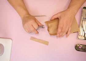 Podiatrist hands opening a bag with sterile stainless steel instruments for a professional pedicure photo