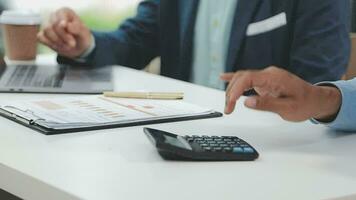 Financial analysts analyze business financial reports on a digital tablet planning investment project during a discussion at a meeting of corporate showing the results of their successful teamwork. video