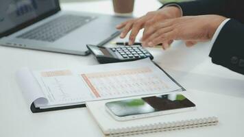 Financial analysts analyze business financial reports on a digital tablet planning investment project during a discussion at a meeting of corporate showing the results of their successful teamwork. video