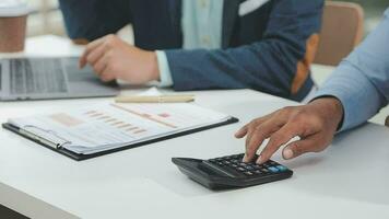 Financial analysts analyze business financial reports on a digital tablet planning investment project during a discussion at a meeting of corporate showing the results of their successful teamwork. video