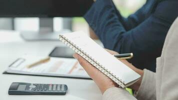 Financial analysts analyze business financial reports on a digital tablet planning investment project during a discussion at a meeting of corporate showing the results of their successful teamwork. video