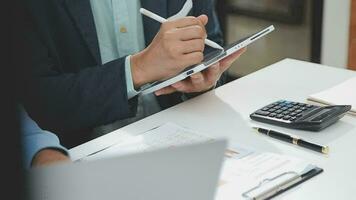 Financial analysts analyze business financial reports on a digital tablet planning investment project during a discussion at a meeting of corporate showing the results of their successful teamwork. video