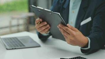 Financial analysts analyze business financial reports on a digital tablet planning investment project during a discussion at a meeting of corporate showing the results of their successful teamwork. video