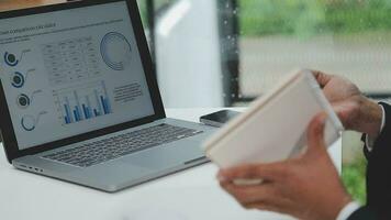 Financial analysts analyze business financial reports on a digital tablet planning investment project during a discussion at a meeting of corporate showing the results of their successful teamwork. video