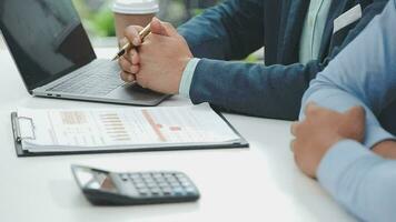 Financial analysts analyze business financial reports on a digital tablet planning investment project during a discussion at a meeting of corporate showing the results of their successful teamwork. video