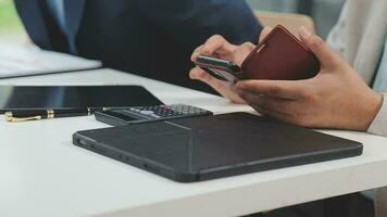 Financial analysts analyze business financial reports on a digital tablet planning investment project during a discussion at a meeting of corporate showing the results of their successful teamwork. video