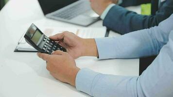 Financial analysts analyze business financial reports on a digital tablet planning investment project during a discussion at a meeting of corporate showing the results of their successful teamwork. video