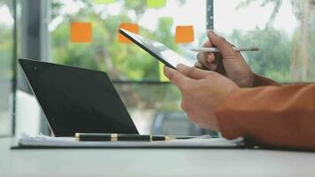 Financial analysts analyze business financial reports on a digital tablet planning investment project during a discussion at a meeting of corporate showing the results of their successful teamwork. video