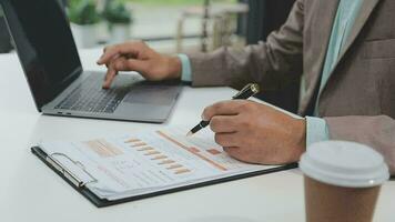 Financial analysts analyze business financial reports on a digital tablet planning investment project during a discussion at a meeting of corporate showing the results of their successful teamwork. video