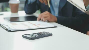 Financial analysts analyze business financial reports on a digital tablet planning investment project during a discussion at a meeting of corporate showing the results of their successful teamwork. video