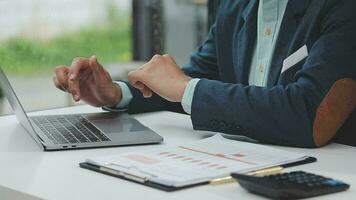 Financial analysts analyze business financial reports on a digital tablet planning investment project during a discussion at a meeting of corporate showing the results of their successful teamwork. video
