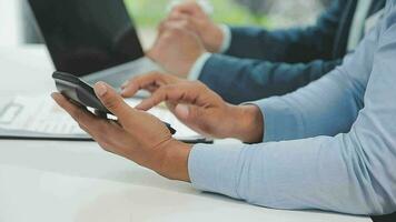 Financial analysts analyze business financial reports on a digital tablet planning investment project during a discussion at a meeting of corporate showing the results of their successful teamwork. video