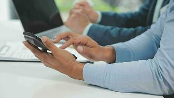 Financial analysts analyze business financial reports on a digital tablet planning investment project during a discussion at a meeting of corporate showing the results of their successful teamwork. video