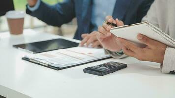 Financial analysts analyze business financial reports on a digital tablet planning investment project during a discussion at a meeting of corporate showing the results of their successful teamwork. video