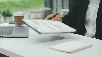 Financial analysts analyze business financial reports on a digital tablet planning investment project during a discussion at a meeting of corporate showing the results of their successful teamwork. video