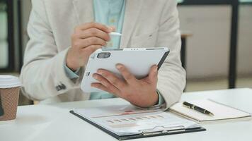 Financial analysts analyze business financial reports on a digital tablet planning investment project during a discussion at a meeting of corporate showing the results of their successful teamwork. video