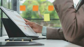 Financial analysts analyze business financial reports on a digital tablet planning investment project during a discussion at a meeting of corporate showing the results of their successful teamwork. video