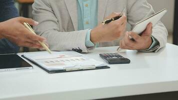 Financial analysts analyze business financial reports on a digital tablet planning investment project during a discussion at a meeting of corporate showing the results of their successful teamwork. video