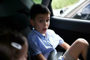 Children wearing a seat belt in the car photo