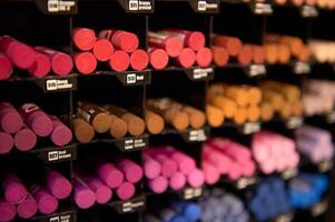 Close-up assortment of colorful multicolored vibrant pencils and crayons on display for sale, in school stationery shop photo